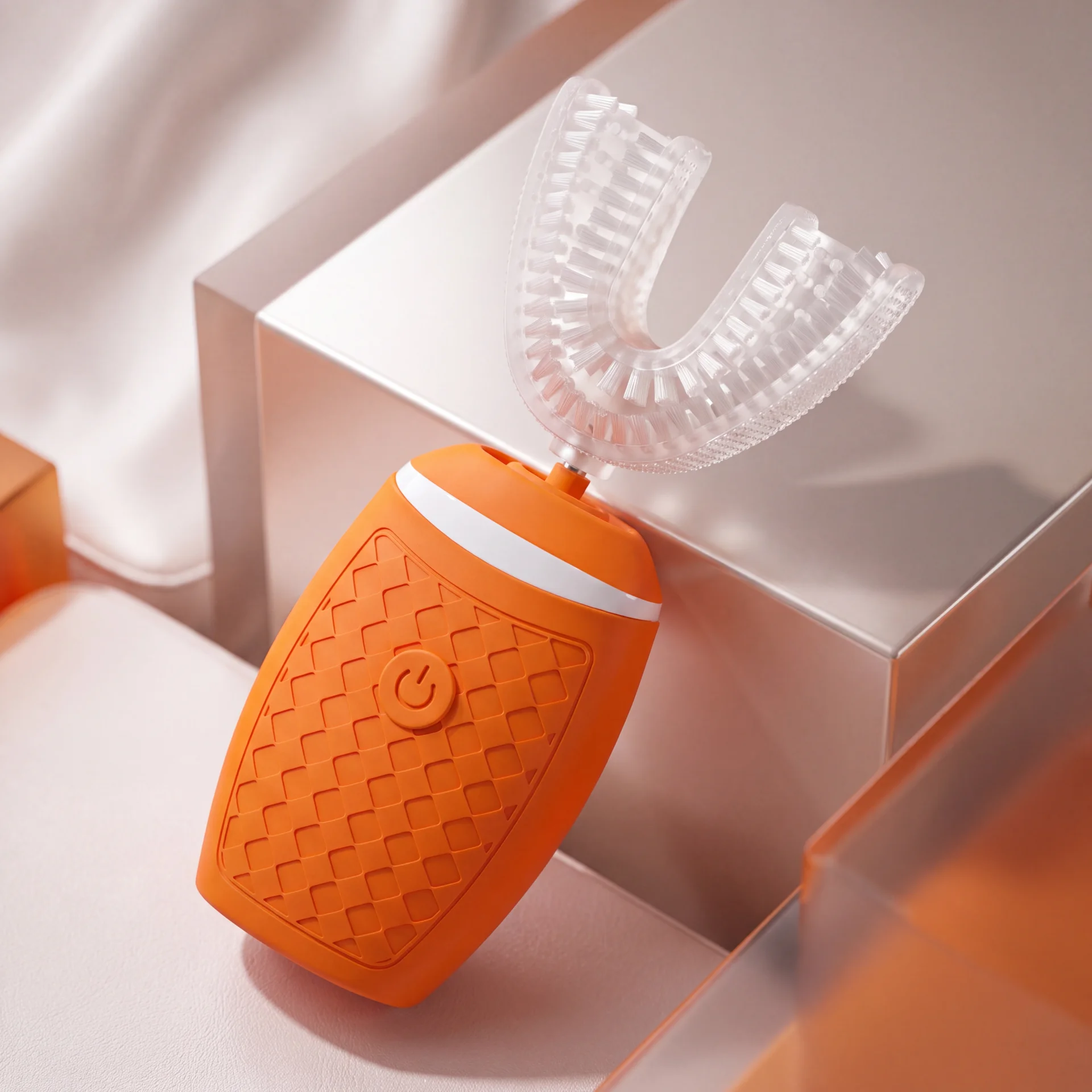 Orange TB-05 toothbrush against a warm geometric backdrop